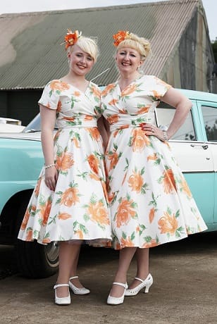 Ladie enjoying Twinwood in their stunning Grace Dresses in Victory Rose Peach.